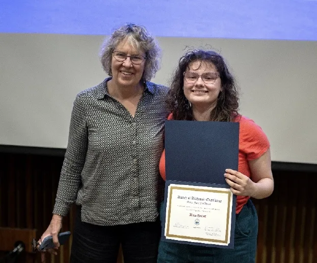 Christie Herbert standing next to Alicia DeCoff holding her award.