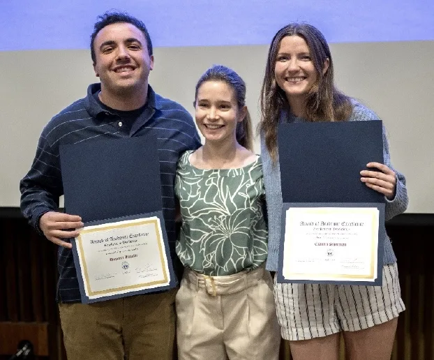 Pamela Sheffler standing between Dominic and Claudia holding their awards.