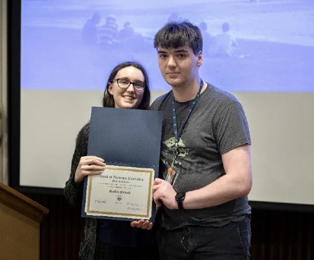 Evelyn Nitch-Griffin presenting Gryffon Foldeak with the Math Excellence award.