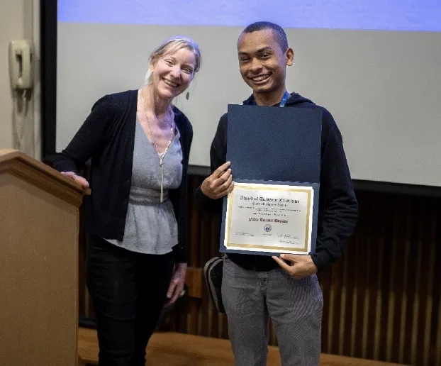 Jan Coplan standing to the left of Favio Terrero Dupiton holding his award.