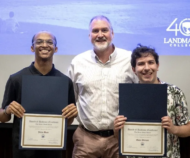 Eric Matte standing between Gavin Wieland and Julian Bond holding up their awards.