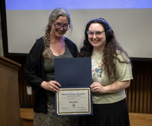 Adrienne Major presenting Jordan Buttie with an award.