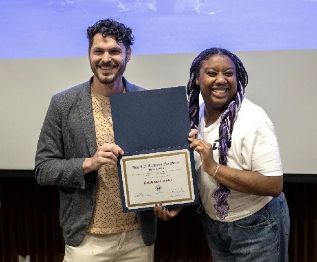 Gyuri Kepes presenting Nailah Quail-Parker with an award.
