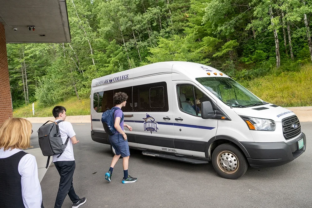 Students getting into a Landmark shuttle.