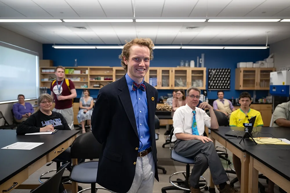 Dylan Sullivan standing in front of a class of students