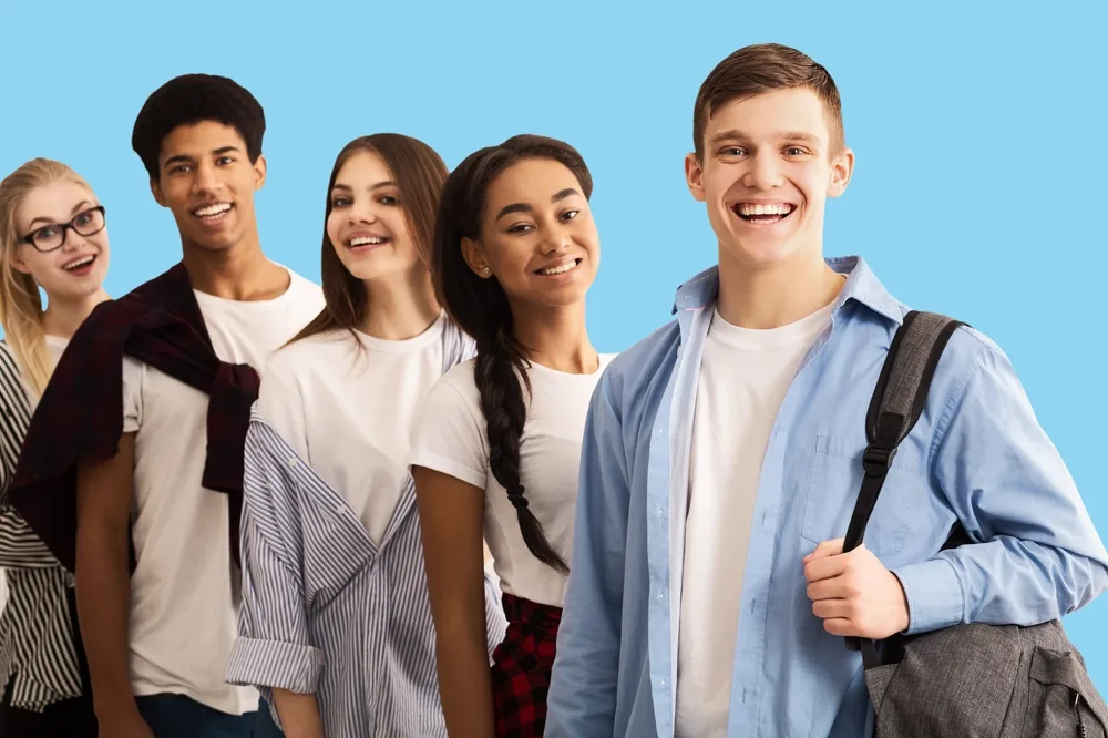 A group of five students smiling.