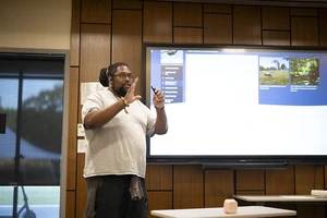 Landmark College student Anastasio Bonhomme presents a slide deck on his experiences as part of the AIE-STEMPLOS program.