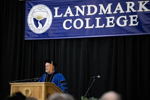 Landmark College President Jim Dlugos standing at a podium.