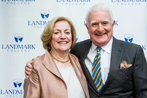 Charles and Nan Strauch pictured in front of a Landmark College banner.