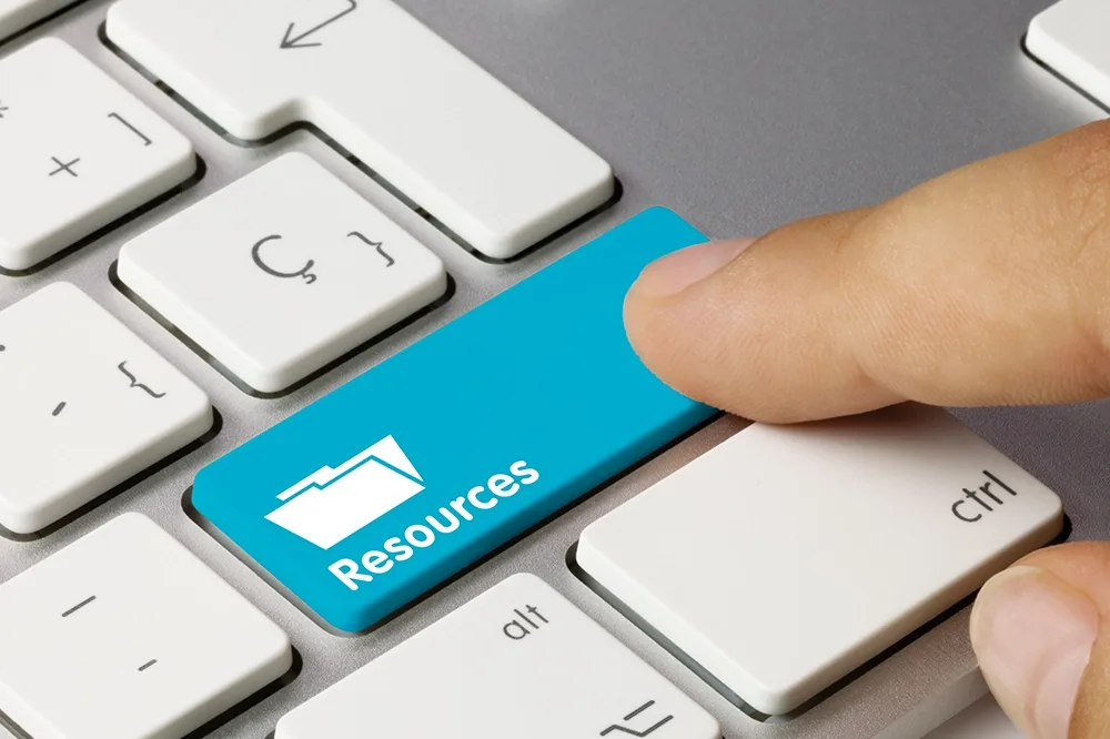 Close up of a keyboard with a blue button saying Resources.