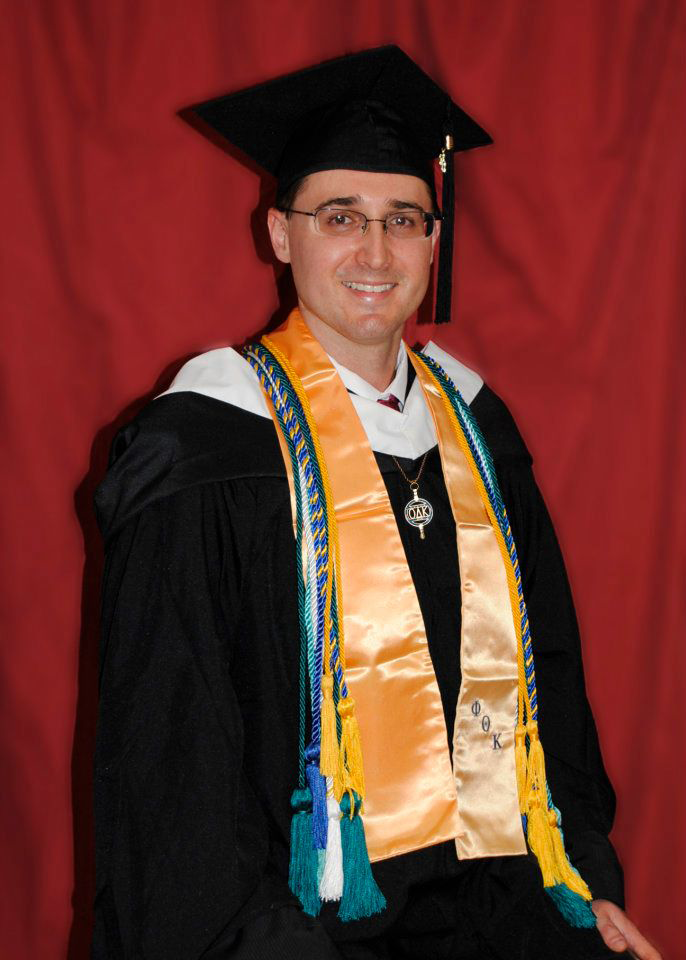 Chris Mathey in graduation regalia.