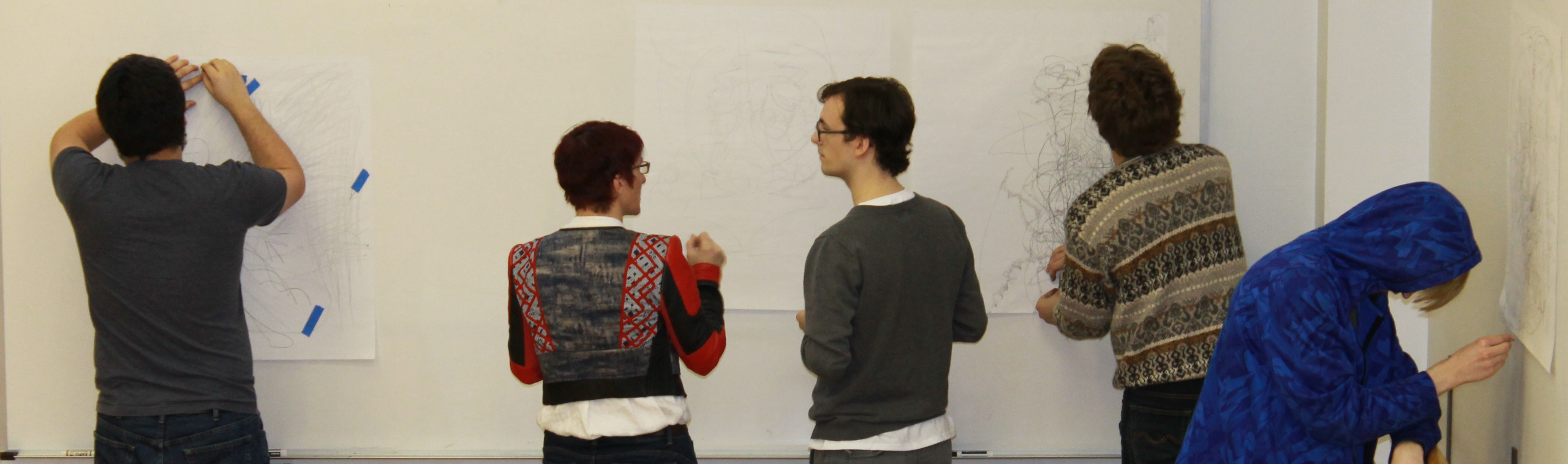 Jean Cherouny ’87 with four other Landmark College students in March of 2017 drawing or observing drawings on papers taped to a wall.