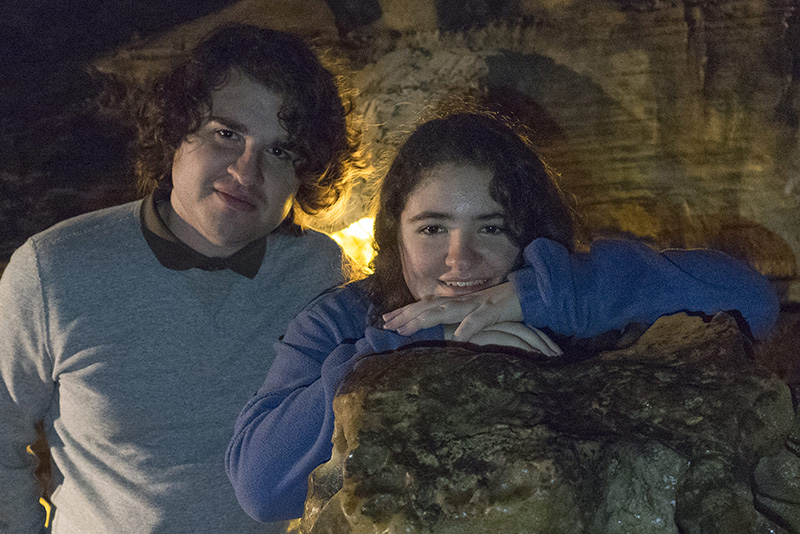 Seth Michaela in a dim cave setting with rock formations.