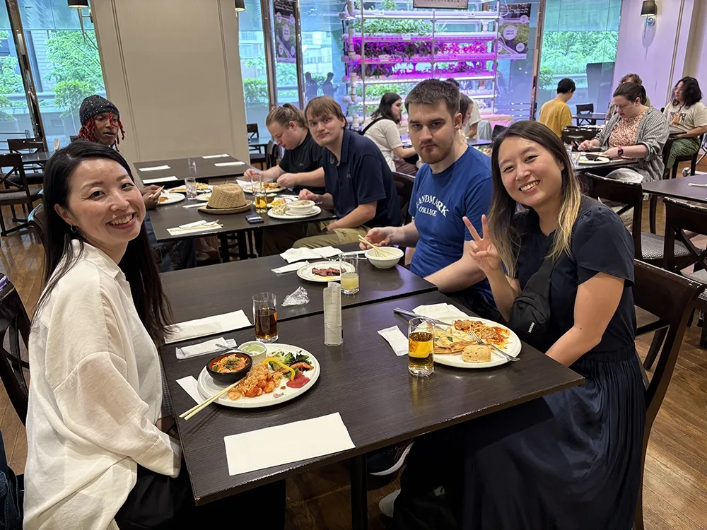 People dining in a casual restaurant. Others eat and chat at nearby.