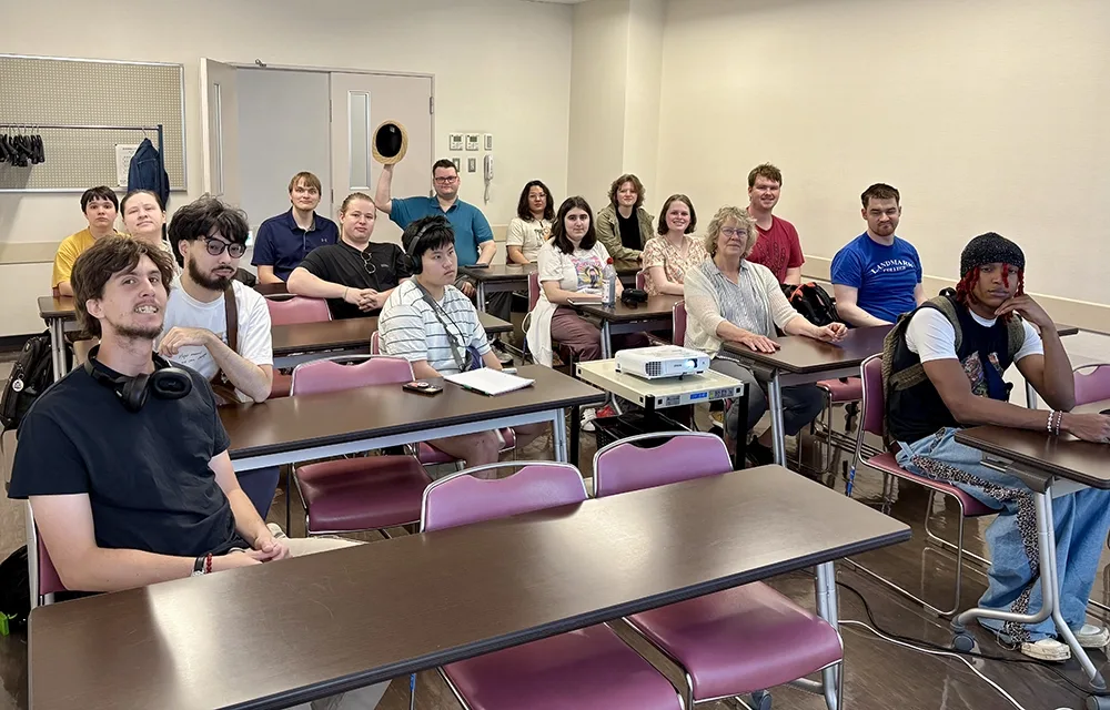 A group of people sitting in a classroom.