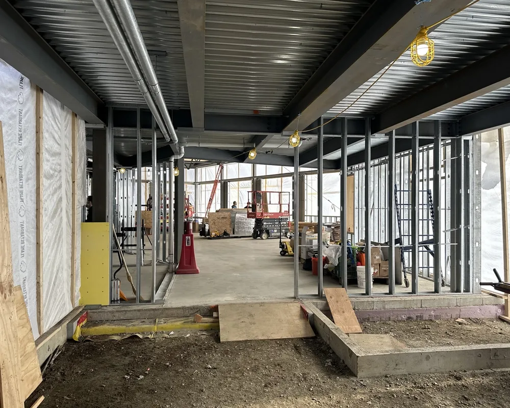 Interior of construction showing wall framing and concrete slab floor