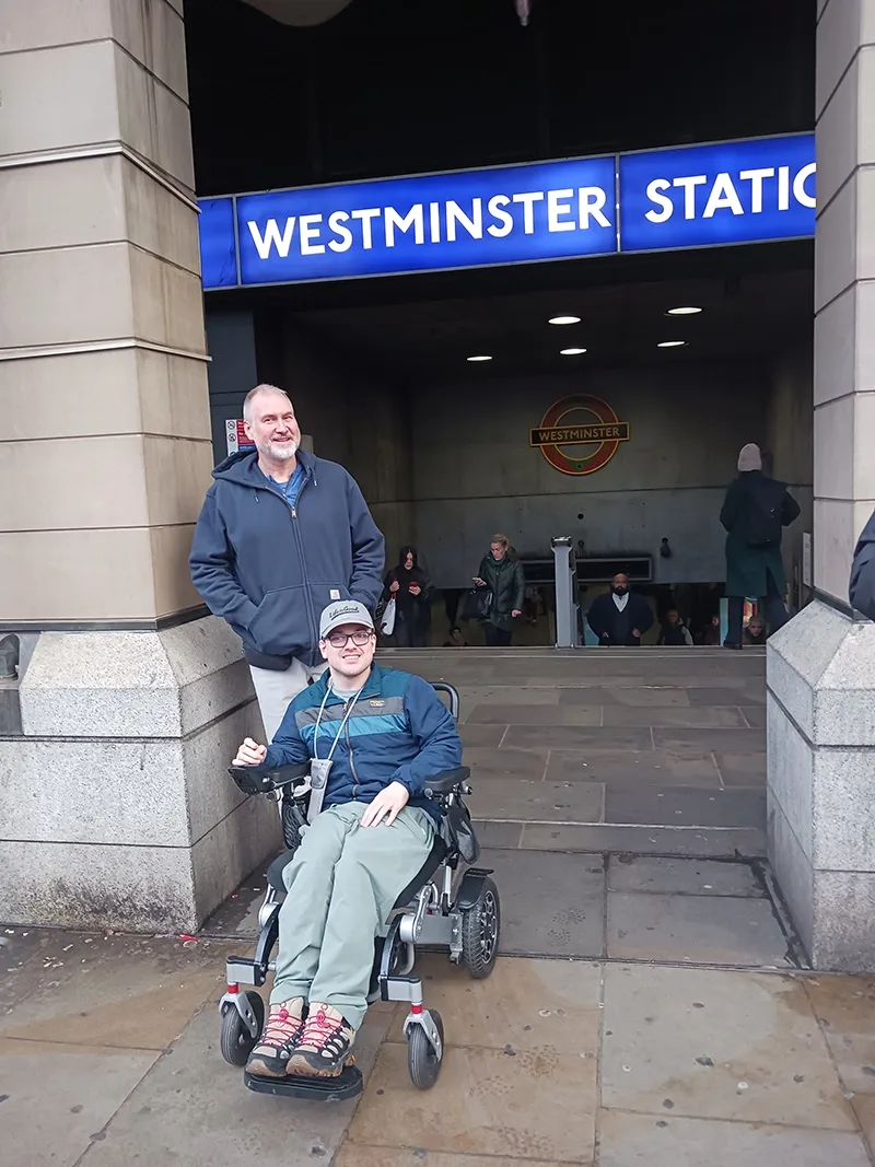 Student in a wheelchair in front of an underground train station