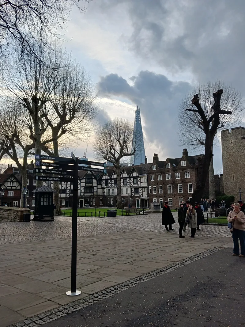A view from a stone courtyard in the grounds of a historic palace in central London with the shard skyscraper pictured in the background.