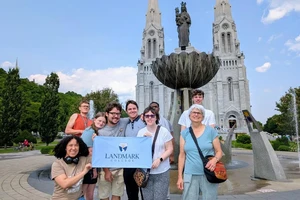 a photo of a group in front of a fountain