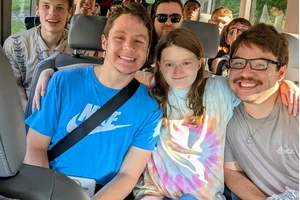 Students sitting in a van