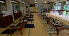 A room with tables and food on mats.