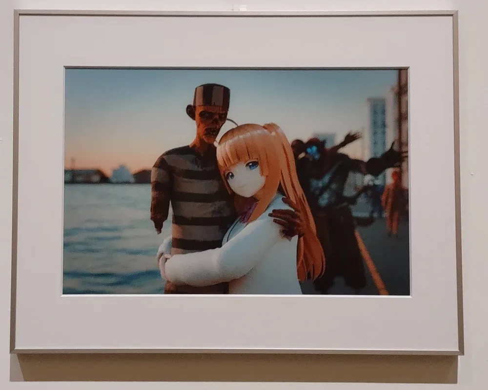 A photo frame with digital 3D art of a video game avatars of an anime girl and zombie taking a photo by the ocean.