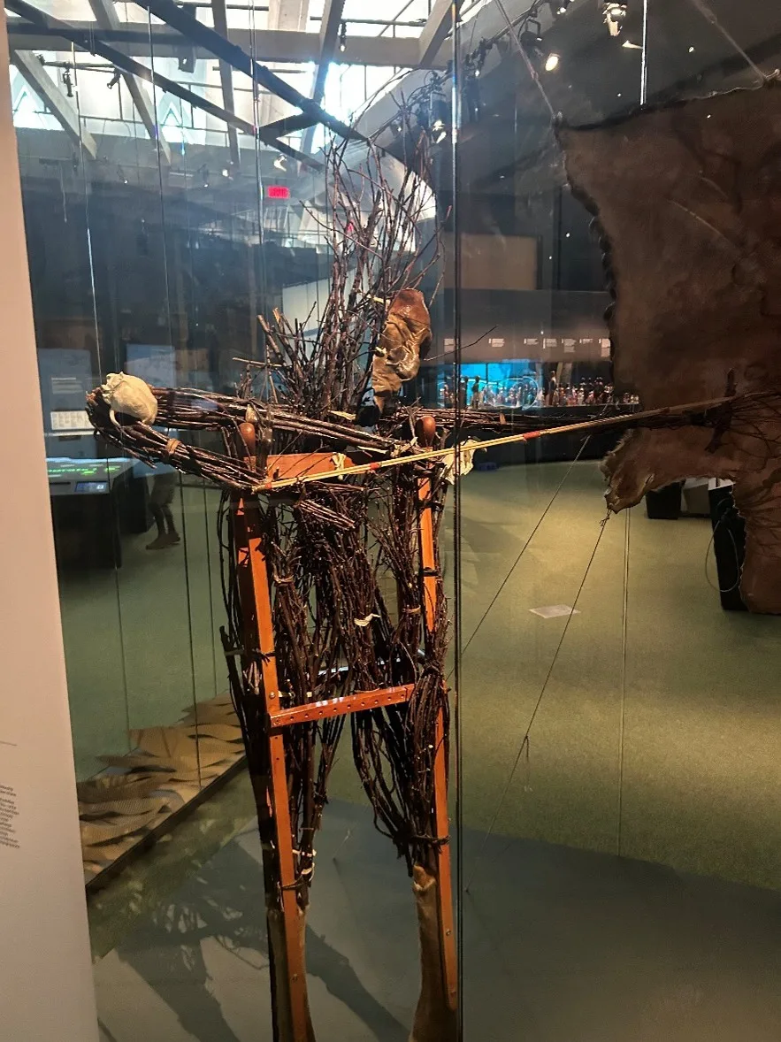 a sculpture of sticks and other materials in the shape of a man