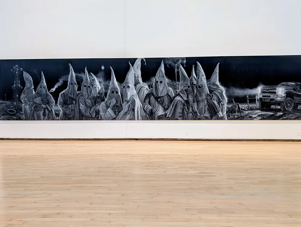 Image of mural depicting several figures in white KKK hoods