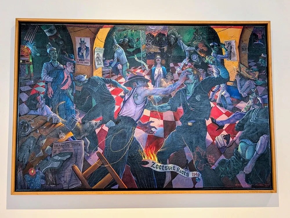colorful mural depicting violence and other activity inside a music hall