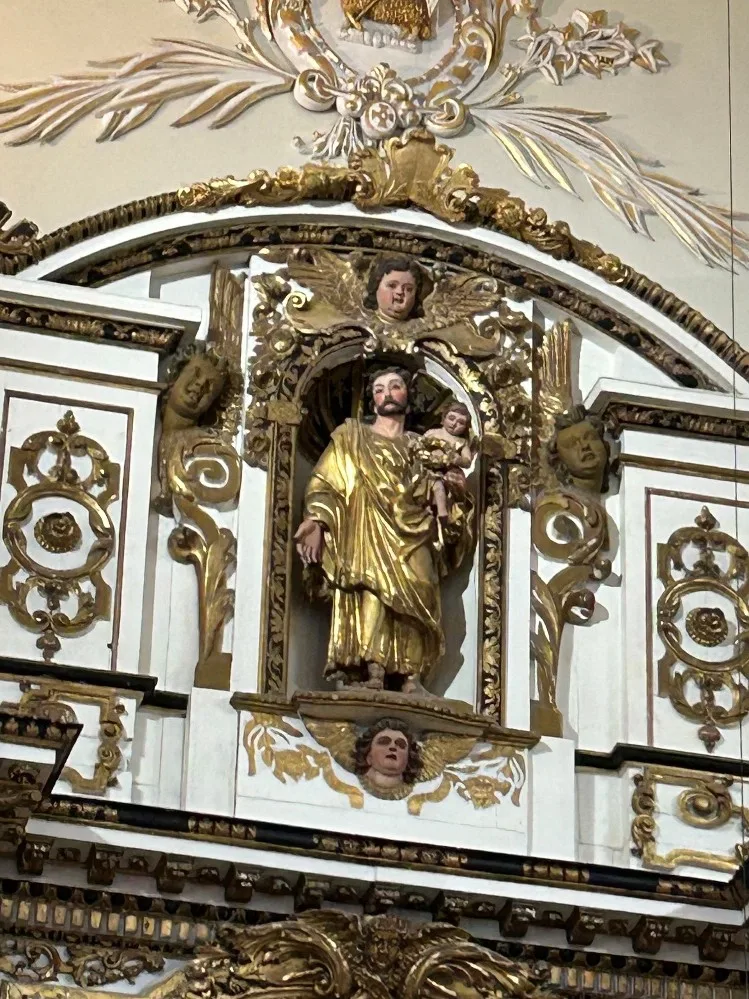 A golden sculpture attached to a wall