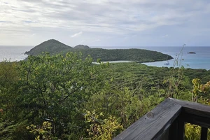 view of sea and island from a balcony