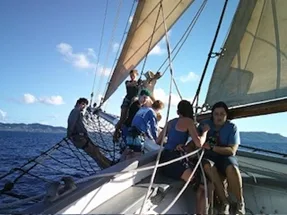 Six students working on a sailboat
