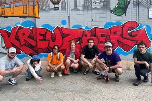 group of students in front of street art that spells out K-R-E-U-Z-B-E-R-G