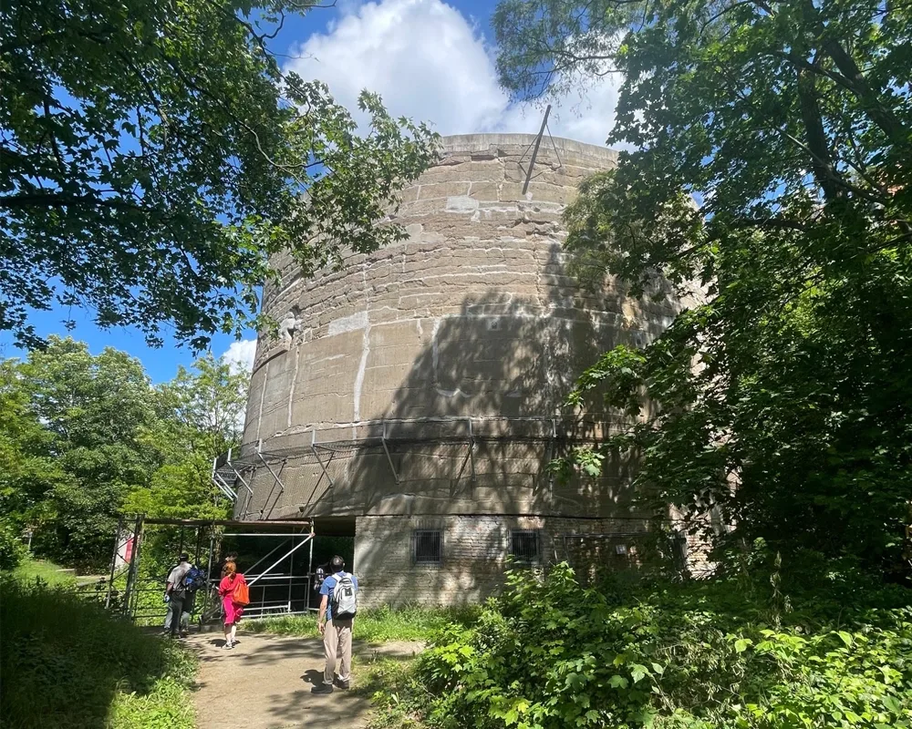 Large cylindrical structure with students walking towards it