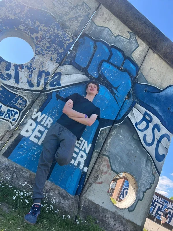 student leaning back against a street art