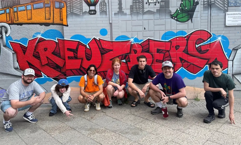 group of students in front of street art that spells out K-R-E-U-Z-B-E-R-G.