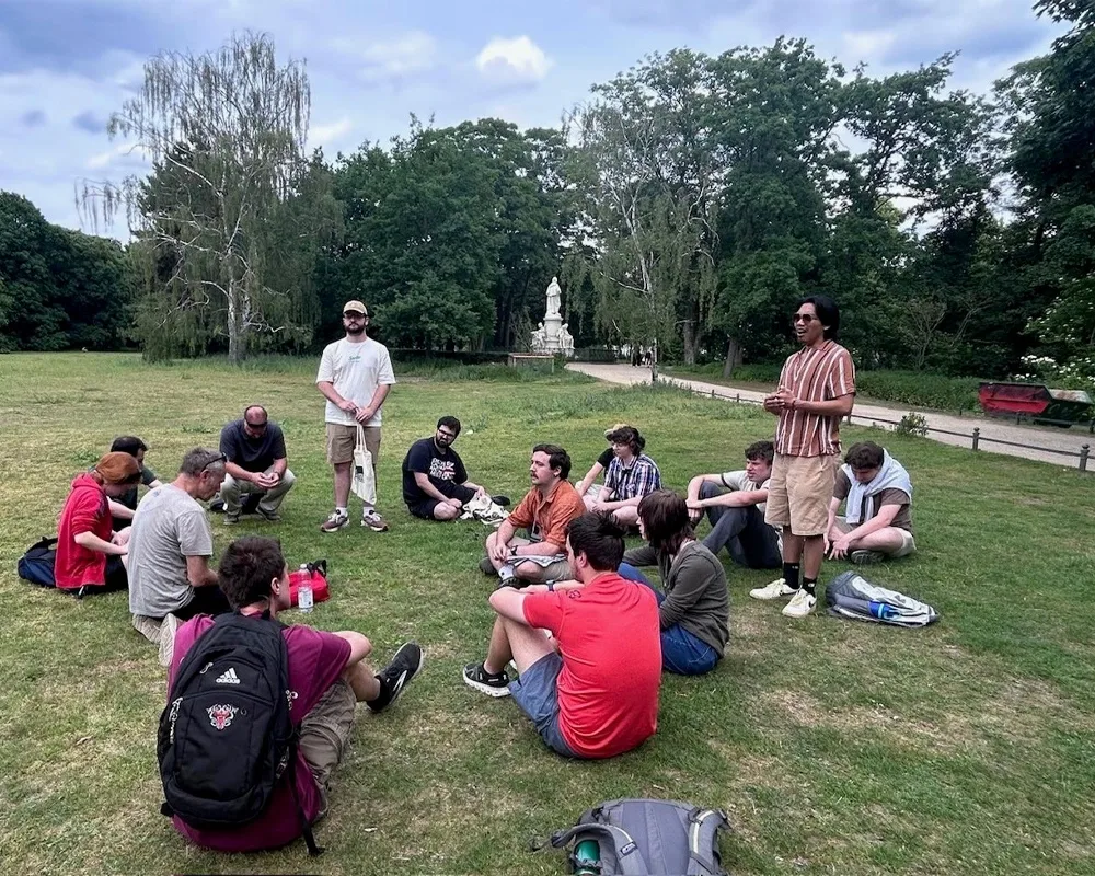 student group sitting in a circle in a public park