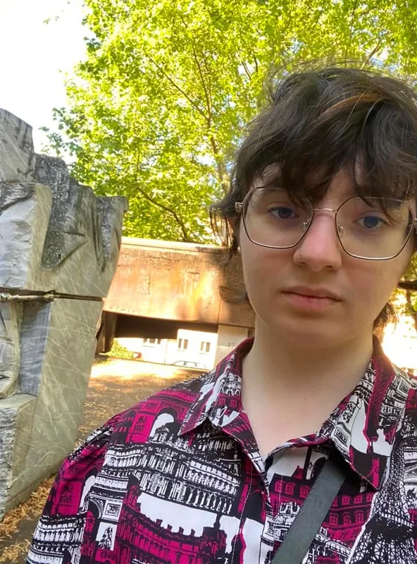 close up of a sober person in front of marble sculpture