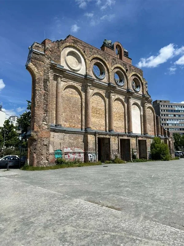 picture of a destroyed building with one wall standing