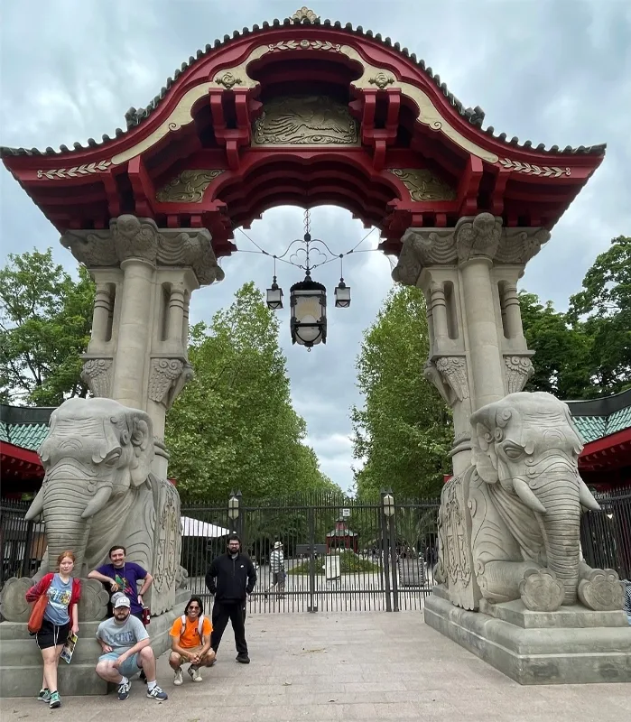 group standing in front of large, Japanese gate with elephant sculptures
