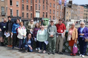 Landmark College Ireland Program standing on the Capel Street Bridge with the tour leader his aunt and his wife who is a nun from California