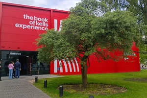 exterior of a bright red building with writing that says the book of kells experience