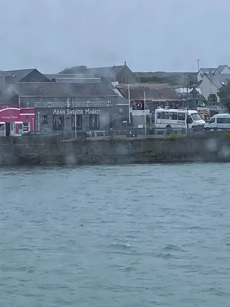A picture across the water of the Aran Sweater Market and the congested street in front of it.