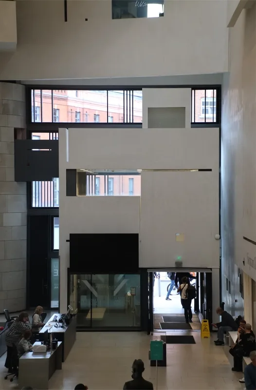 View from the stairs looking down on the entrance to the National Gallery from the interior.
