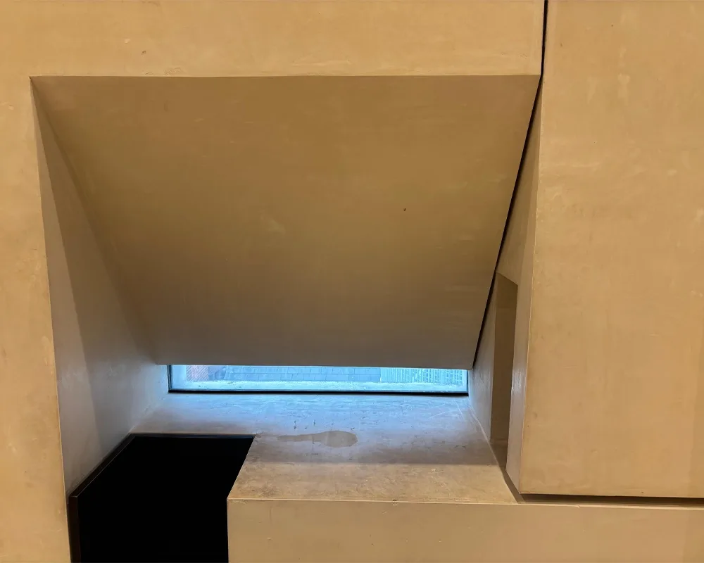 a window with a diagonal slope covering most of the glass. A rectangular shape can also be seen on the right side of the cut-in window.