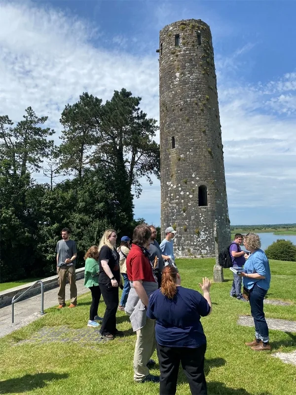 A photo of a round tower under which the class is gathered