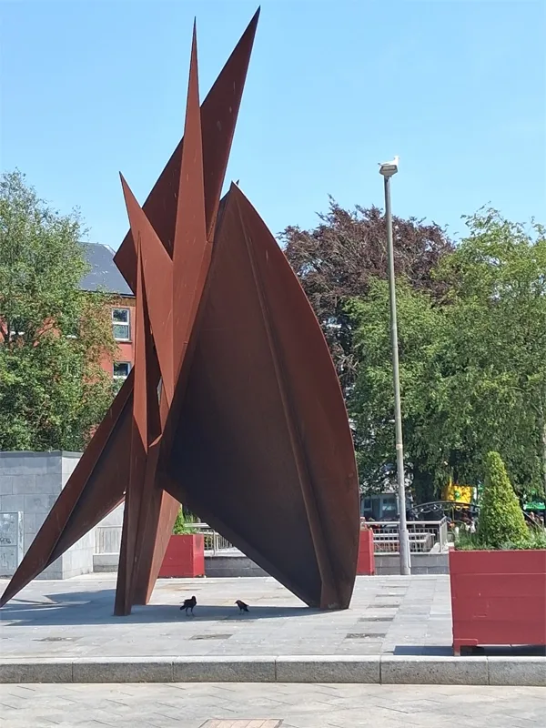 A photo of the sculpture—red sails of cast iron--in the center of Eyre Square in Galway