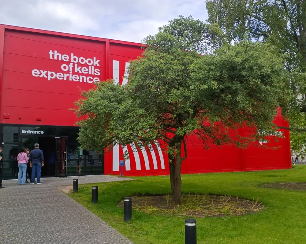 exterior of a bright red building with writing that says the book of kells experience