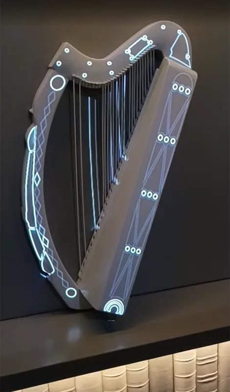 brown harp with ornate decorations on display