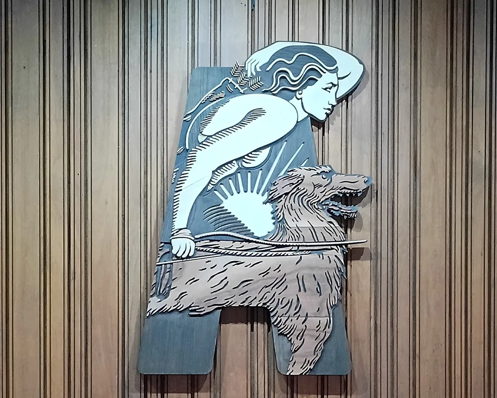 Abbey Theatre logo on wall, which is a profile of a man holding a bow and a dog by his side